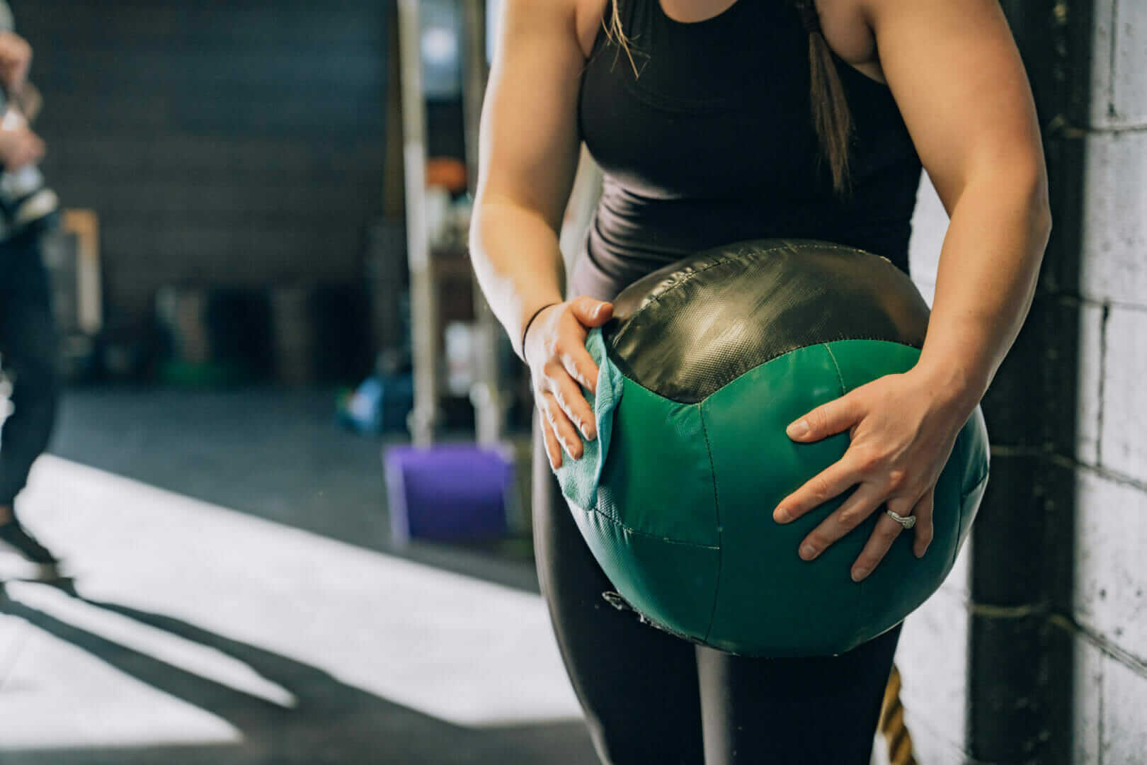 Women holding weighted medicine ball