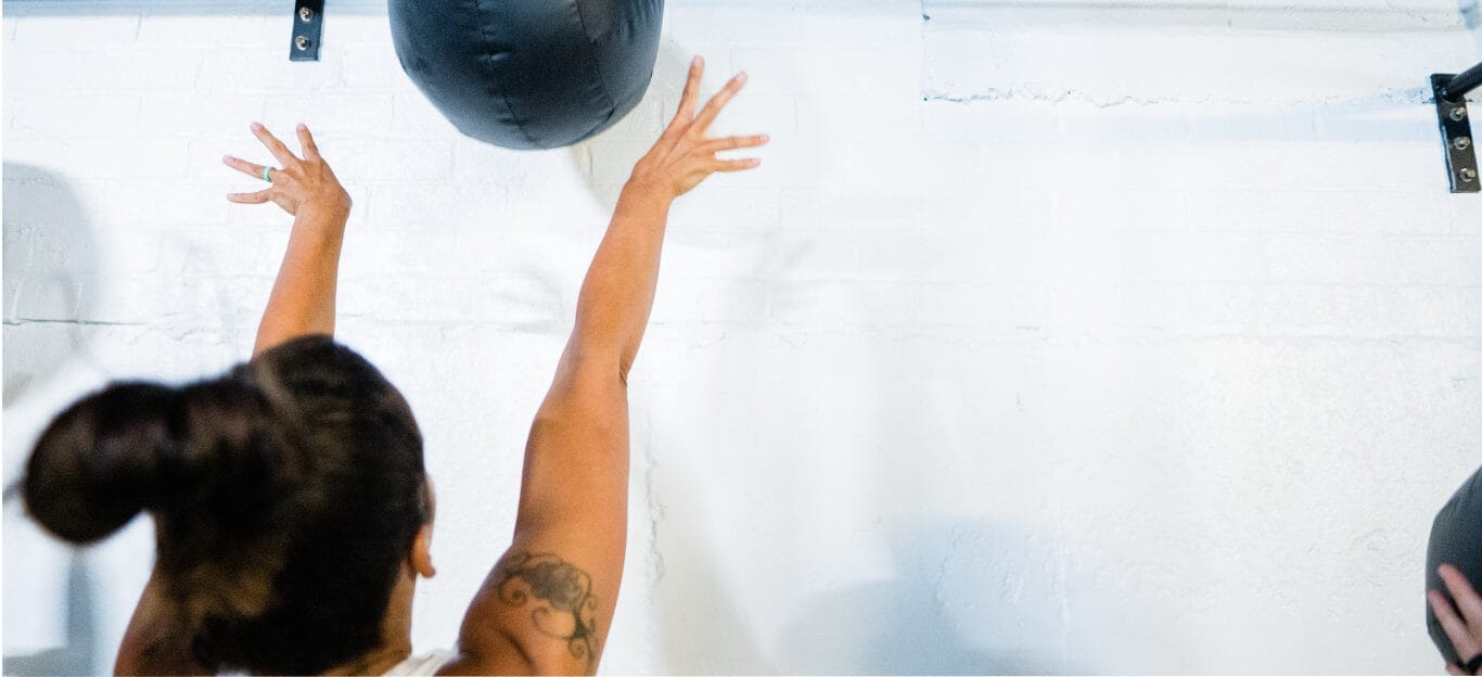 Women training with medicine ball